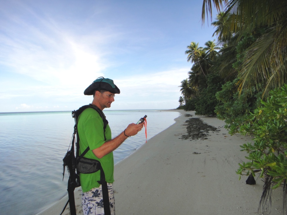 Dylan Kessler, project leader using GPS to locate rat traps set on Pasa Island.